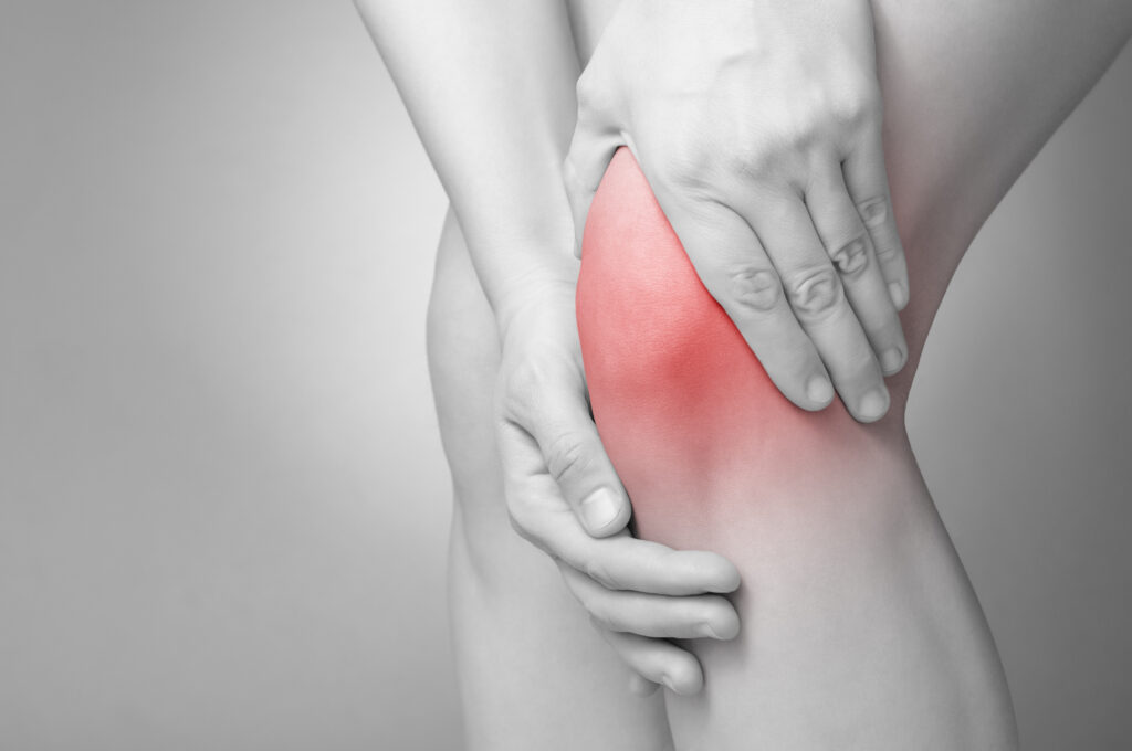 knee pain - person holding knee